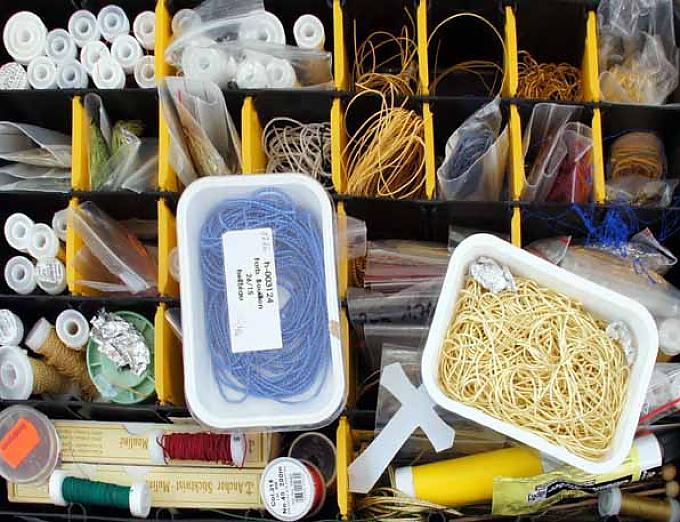 Drahtrollen, Bouillondraht und Perlen in vielen Farben sauber geordnet Drahtrollen, Bouillondraht und Perlen in vielen Farben sauber geordnet